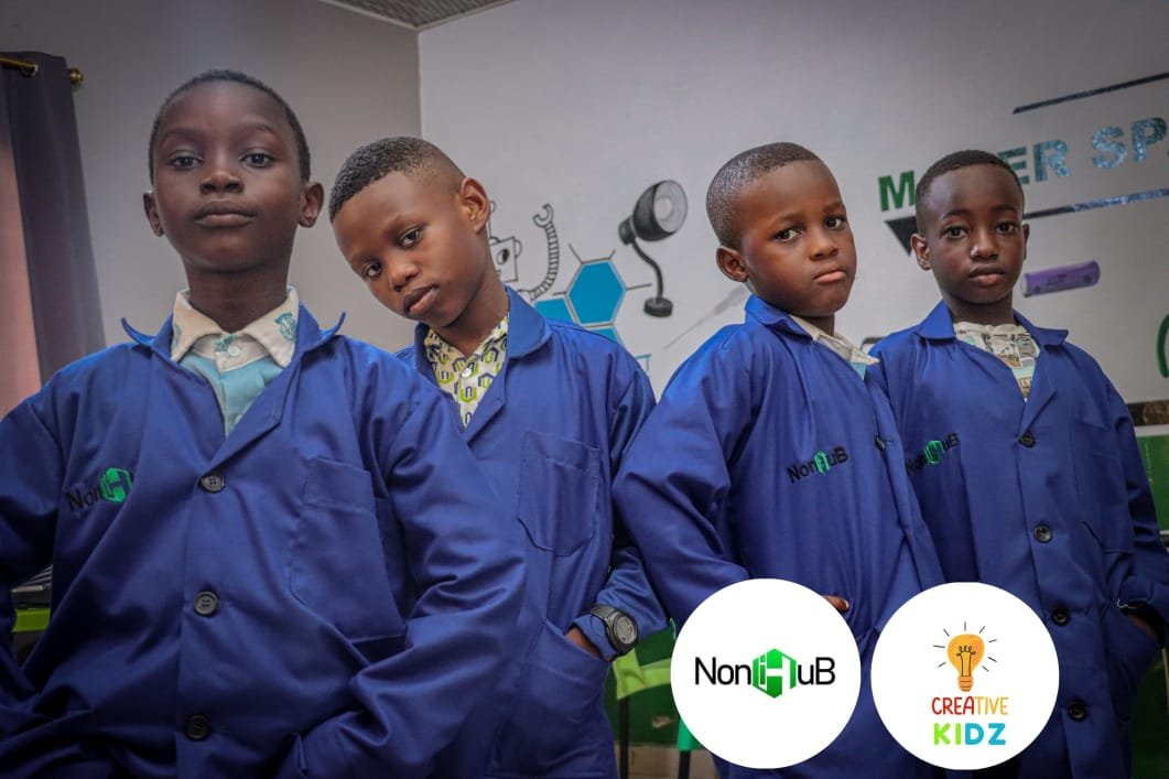 Students in blue uniforms at Noni Makerspace working on projects